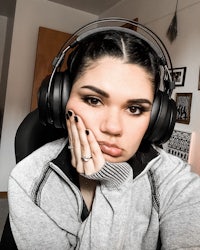 a woman wearing headphones in front of a desk